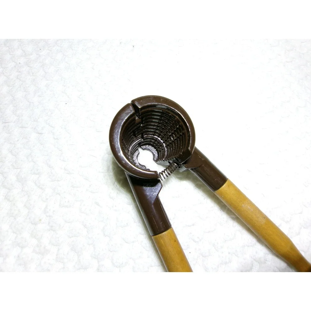 Vintage Spring Loaded Nutcracker‎ Brown Metal with Wood Handles Conical Design